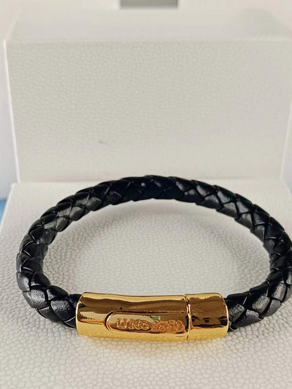 Bracelet in metal clad with gold and leather